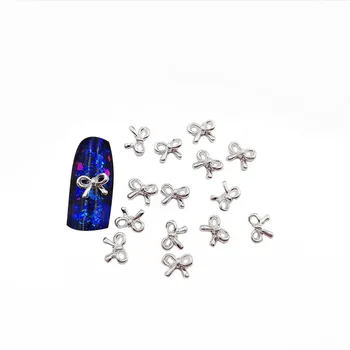 50pcs/bag 3D Hollow Bow Tie Золото / Серебро Блестящий Дизайн Ногтей Подвески Сплав Металл Ногти Подвески DIY Украшения для ногтей Детали украшения для ногтей